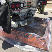 Concrete washout machine with 'Outpak' branding on a clear plastic sheet.