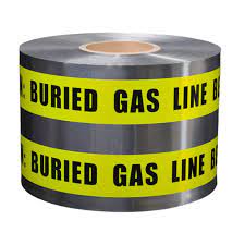 A roll of detectable yellow gas marking tape with the message 'CAUTION GAS LINE BURIED BELOW' printed on it.