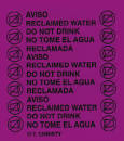 A purple reclaimed water riser marker with text indicating it is for marked water lines and to not drink the water.