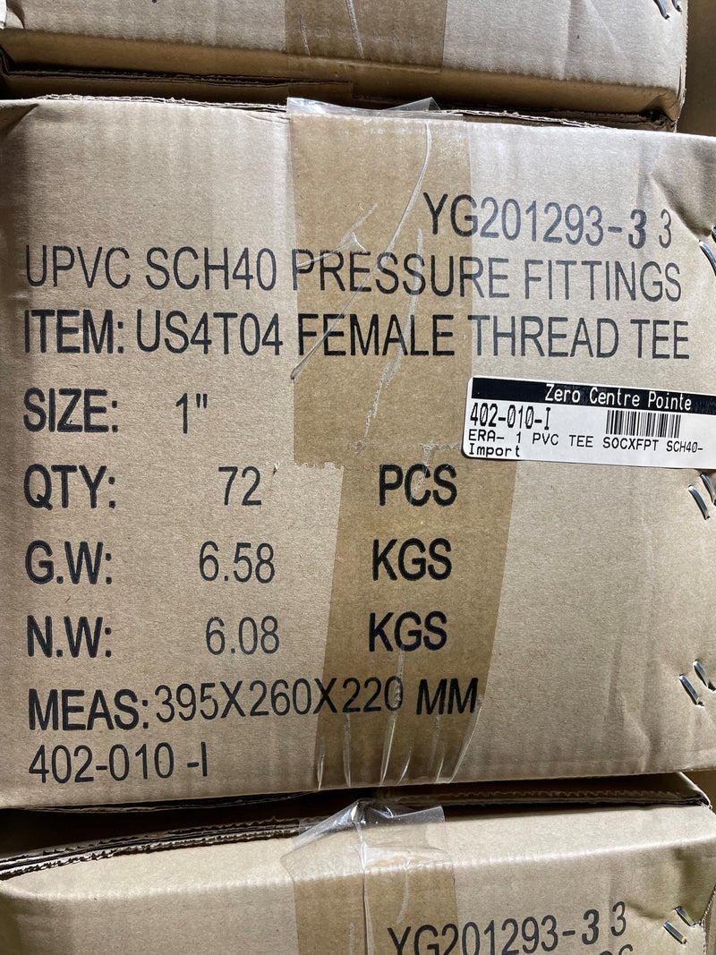 A close-up of a cardboard shipping box printed with product details for UPVC SCH40 pressure fittings, specifically a female thread tee, size 1 inch, with a barcode label from Zero Centre Point.