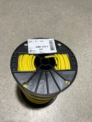 A spool of yellow irrigation wire in a black plastic casing, labeled with specifications.