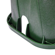 Close-up of a green plastic container with a white object inside on a white background