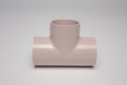 A beige 1 inch PVC UVR tee fitting with socket connections on all three sides.