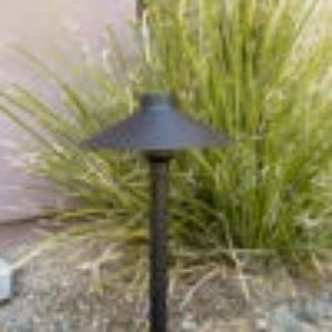 Black outdoor light fixture on a grassy area