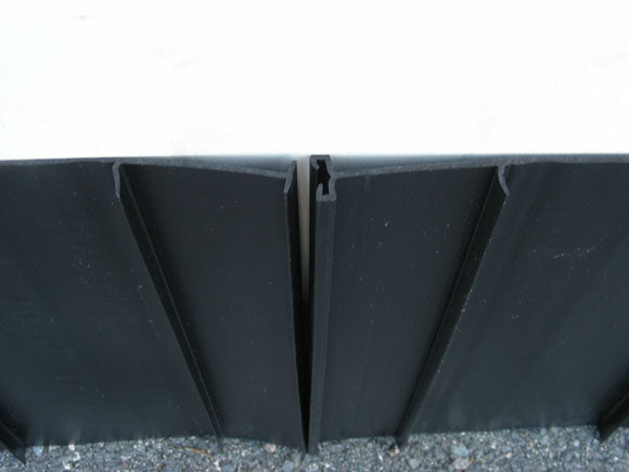 A black, solid-colored root barrier panel designed for garden or landscaping use.