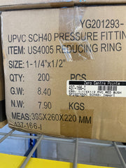 A brown cardboard box printed with product details for a UPVC SCH40 pressure fitting, item US4005 reducing ring, size 1-1/4 x 1/2, quantity 200 PCS, on a metal wire shelf.