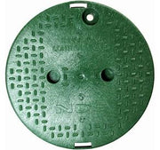 Green manhole cover with textured surface on a white background