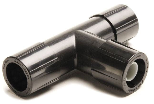 A black and silver metal compression tee fitting, used for irrigation systems.