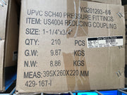A brown cardboard shipping box printed with product details for UPVC SCH40 pressure fittings, specifically a reducing coupling item US4004. The box shows size, quantity, gross weight, net weight, and dimensions, with a barcode label from Xero Centre Pointe.