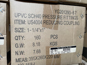 A close-up of a cardboard shipping box printed with product details for UPVC SCH40 pressure fittings, item US4004 reducing coupling, size 1-1/4" x 1", quantity 160 pieces, with a barcode label on the front.