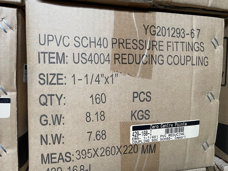 A close-up of a cardboard shipping box printed with product details for UPVC SCH40 pressure fittings, item US4004 reducing coupling, size 1-1/4" x 1", quantity 160 pieces, with a barcode label on the front.