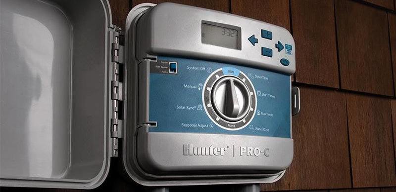 Hunter Pro-C sprinkler controller on a wooden wall