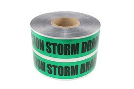 Two rolls of green and white warning tape with text on a white background