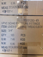 Close-up of stacked cardboard shipping boxes printed with product details for UPVC SCH40 pressure fittings, including a female thread elbow, size 3/4 inch, quantity 160 pieces.