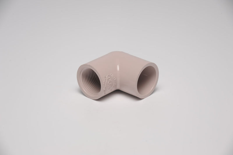 A beige 3/4 inch by 1/2 inch elbow PVC fitting for plumbing.