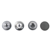 Four metallic buttons of different designs on a white background