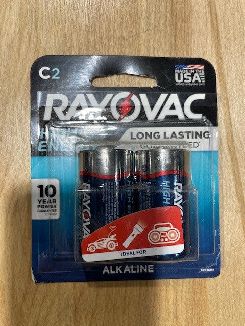 Pack of Rayovac C2 batteries on a wooden surface