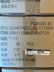 A close-up of a cardboard shipping box printed with product details for UPVC SCH40 pressure fittings, specifically a US4011 female adapter, size 1-1/2 inches.