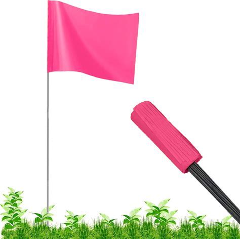 A fluorescent pink wire staff marking flag with a suede/matte finish, displayed in a grassy area, with a visible flag pole.