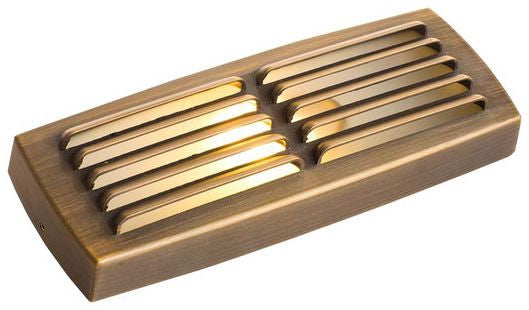 A cast brass step light with an antique bronze finish and a frosted flat glass lens, designed for landscape pathway lighting.