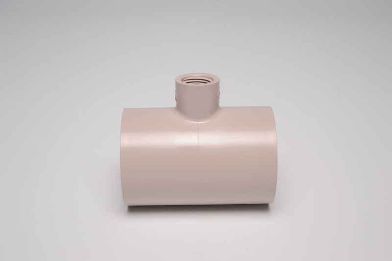 A beige 2 inch by 2 inch by 1 half inch tee-shaped PVC fitting for irrigation supplies.