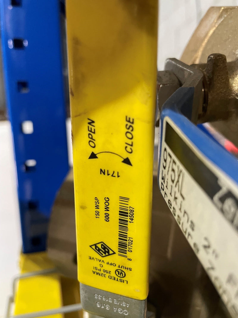 Yellow label with text and barcodes on a metal surface