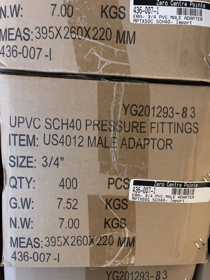 A close-up of stacked brown cardboard shipping boxes printed with product details for UPVC SCH40 pressure fittings, male adaptor, size 3/4 inch, quantity 400 pieces.