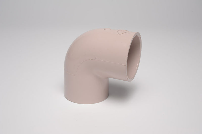 A beige 3/4 inch PVC UVR 90ELL socket fitting, Schedule 40, displayed on a neutral background