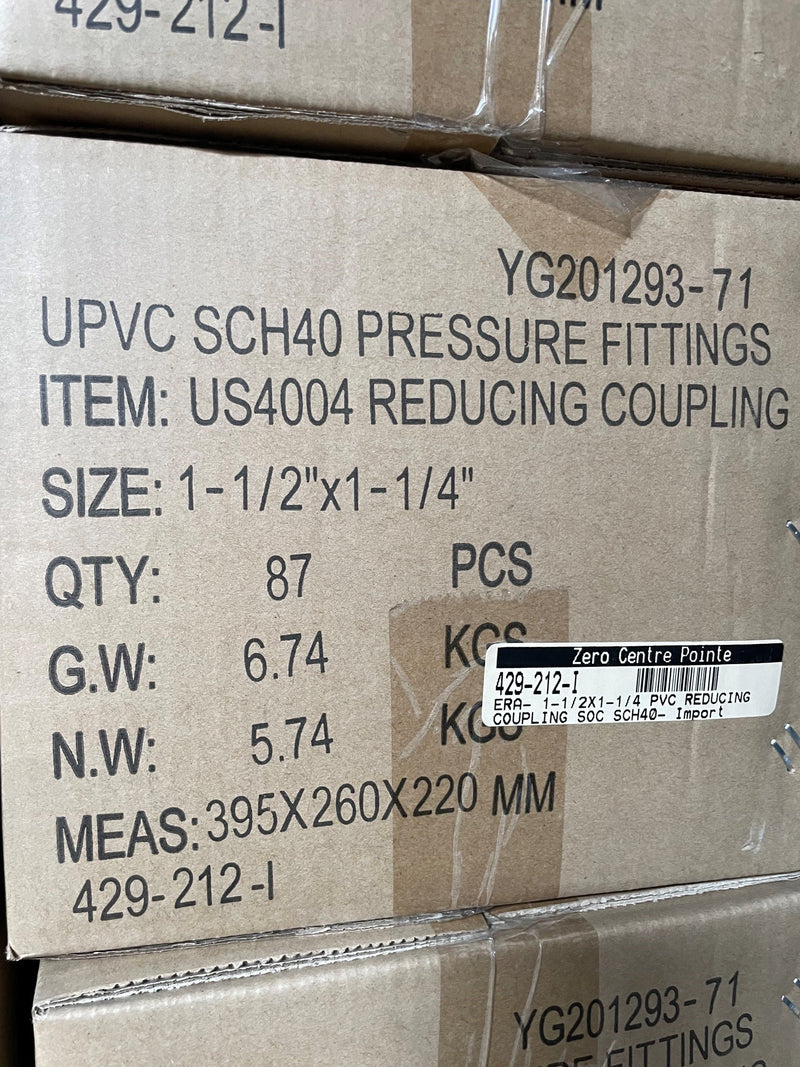 A close-up of a cardboard shipping box printed with product details for UPVC SCH40 PRESSURE FITTINGS, item US4004 REDUCING COUPLING, including size, quantity, weight, and measurements.