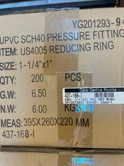 A close-up of a cardboard shipping box printed with product details for a UPVC SCH40 pressure fitting, including item number YG201293-9, size 1-1/4"x1", quantity 200, and a barcode label from Zero Centre Pointe.