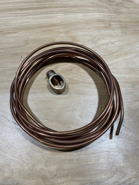 Coiled brown bare copper ground wire with a ground rod clamp