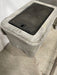 A concrete valve box with a hinged cast iron lid.