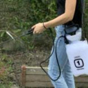 Person using a pressure washer outdoors