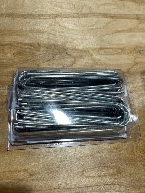A pack of Rain Bird tie down stake staples, galvanized steel, for securing drip irrigation tubing.