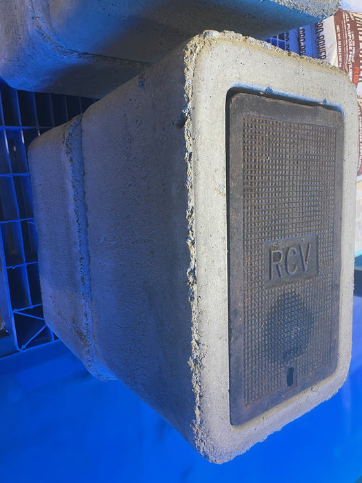 Concrete block with a textured surface and 'RCV' branding on a blue background