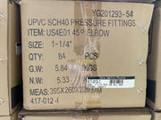 A cardboard shipping box for UPCVC SCH40 pressure fittings, specifically a 45-degree elbow. The box contains 84 pieces and has printed specifications including size, quantity, gross weight, net weight, and dimensions.