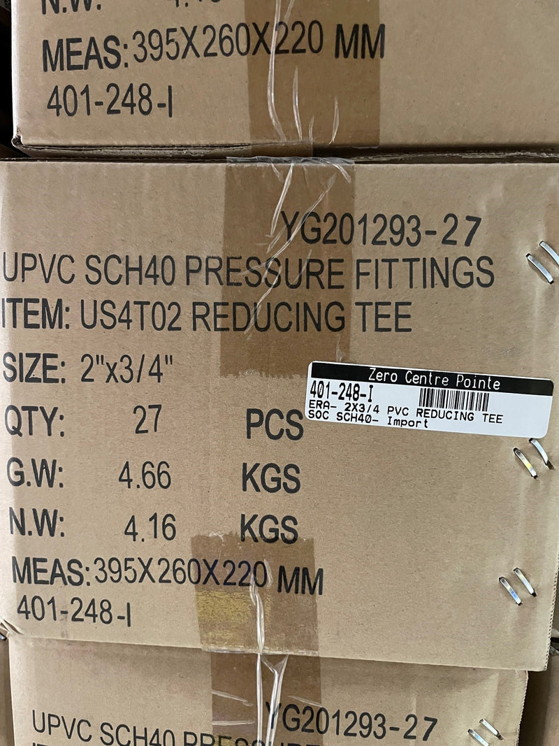 A close-up of stacked cardboard shipping boxes containing UPVC SCH40 pressure fittings, specifically reducing tee valves. The boxes are secured with clear plastic wrap and printed with product details, barcodes, and shipping information.