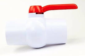 A white PVC compact ball valve with a red 1/4 turn handle, isolated on a white background.