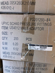A close-up of a brown cardboard shipping box printed with product details for UPVC SCH40 pressure fittings, including item number US4012 male adaptor, size 1 inch, quantity 200 PCS, and a Zero Centre Pointe label.