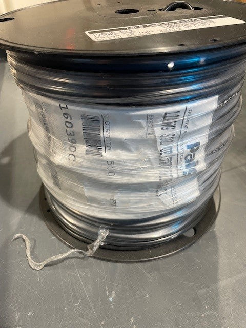 Spool of cable with a label on a gray surface