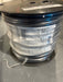 Spool of cable with a label on a gray surface
