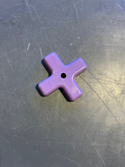 Purple star-shaped object on a metallic surface