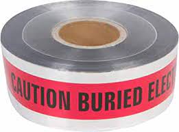 A roll of detectable red electric marking tape with 'CAUTION ELECTRIC LINE BURIED BELOW' printed on it.