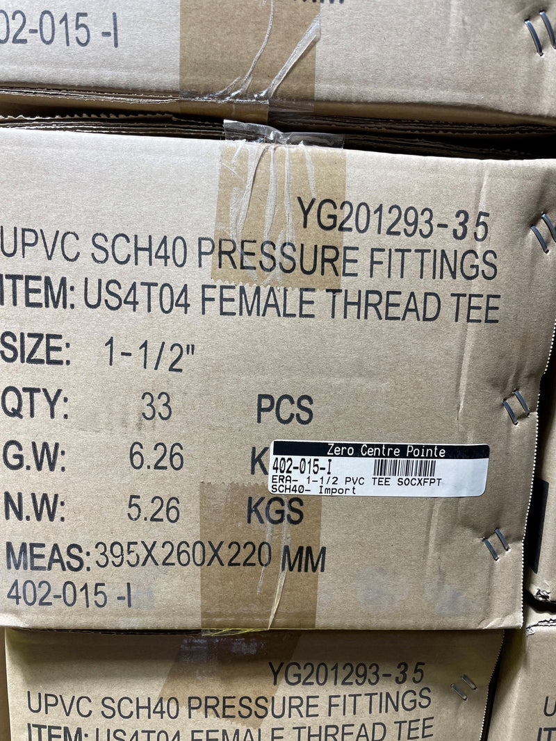 A close-up of a cardboard shipping box printed with product details for UPVC SCH40 pressure fittings, specifically a female thread tee, with a barcode label from Zero Centre Point.