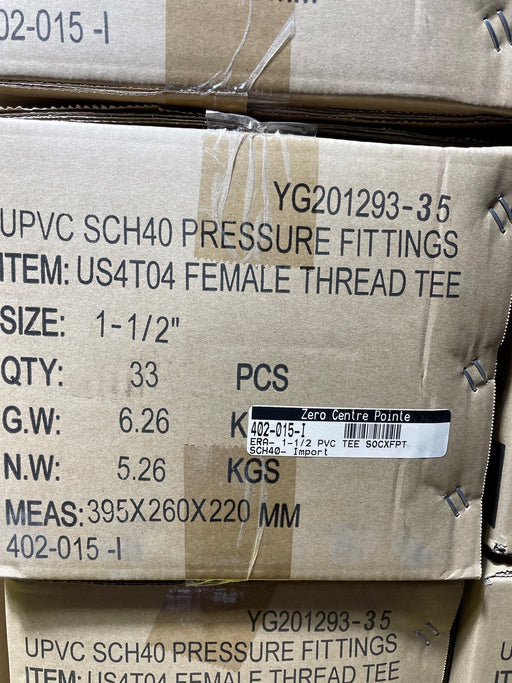 A close-up of a cardboard shipping box printed with product details for UPVC SCH40 pressure fittings, specifically a female thread tee, with a barcode label from Zero Centre Point.