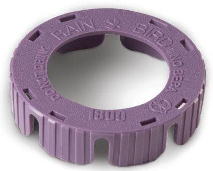 A purple non-potable spray head snap cover from Rain Bird, with the brand and product number 1800 visible.