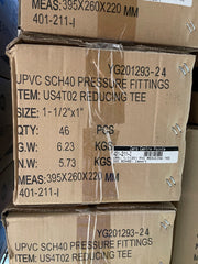 Stacked cardboard shipping boxes for UPVC SCH40 pressure fittings, showing printed product details, size, quantity, and a barcode label.