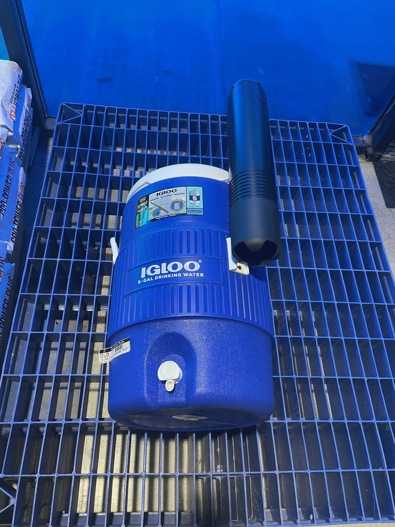 Blue Igloo cooler on a metal surface with a blue background