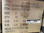 A brown cardboard shipping box printed with product details for UPVC SCH40 pressure fittings, item US4003 coupling, including size, quantity, weight, and measurements.