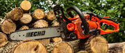 Echo chainsaw on a pile of logs with a blurred natural background